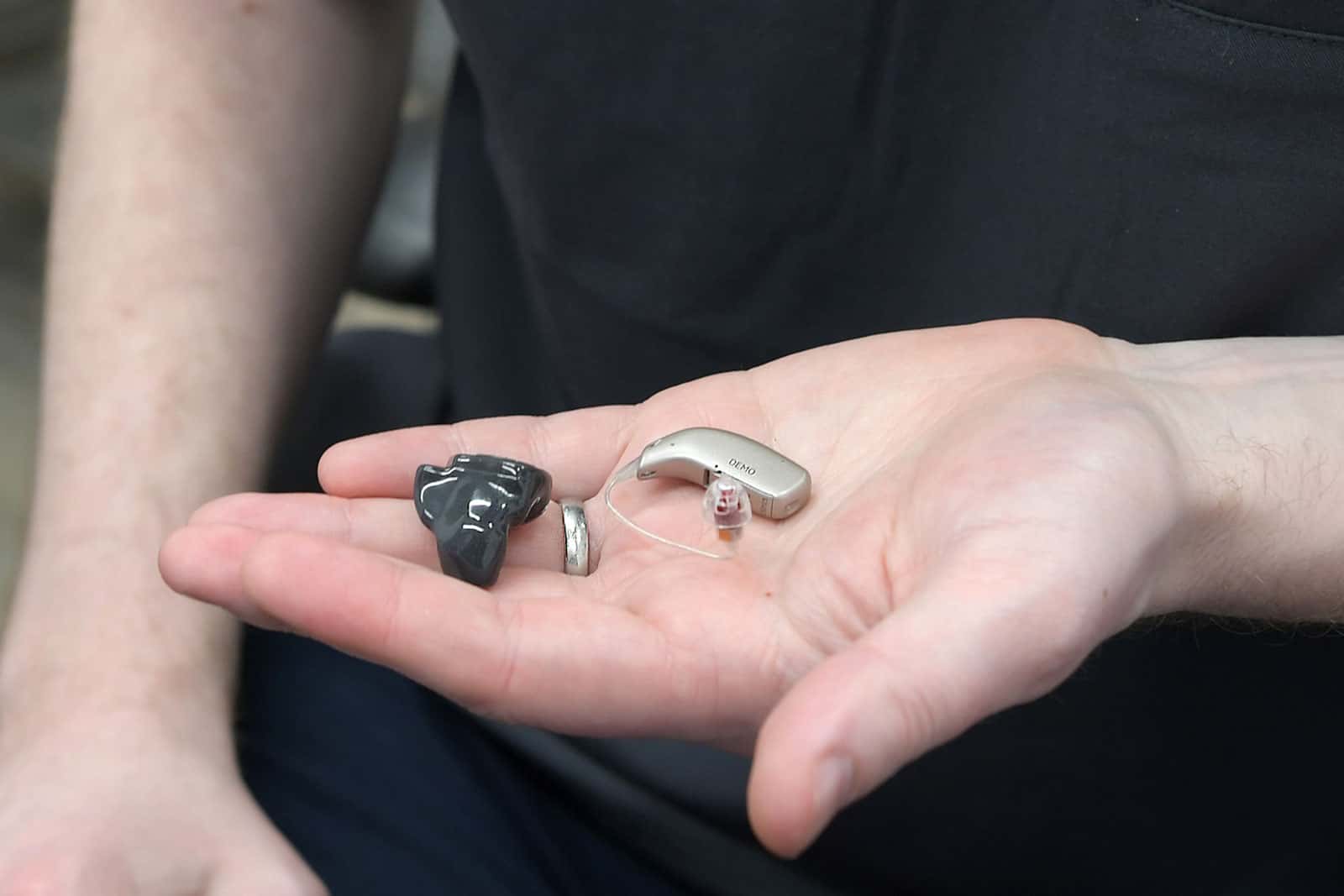 Audiologist holding Resound Omnia Receiver in the Canal and Custom Rechargeable Hearing Aids
