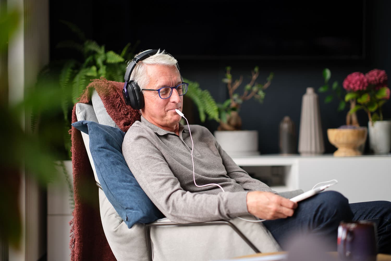 Man using the Lenire tinnitus treatment device