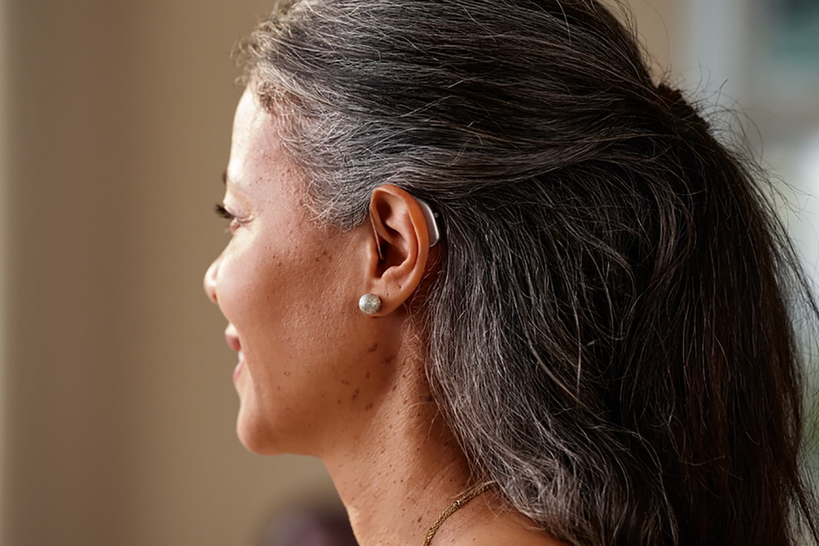 Woman wearing Widex Allure RIC hearing aids