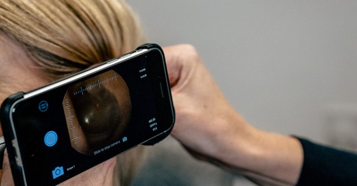 Audiologist checking ear health during a Complete Hearing Assessment