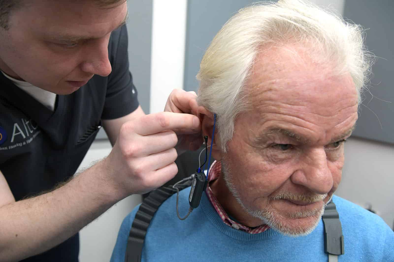 Man having real ear measurements completed with audiologist