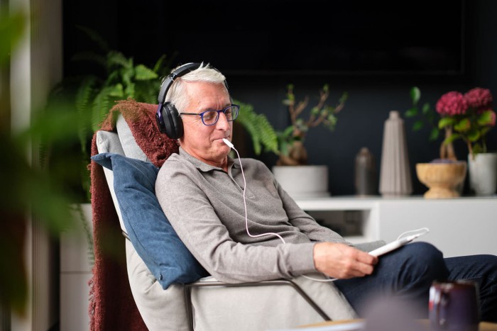 Man using the Lenire tinnitus treatment device