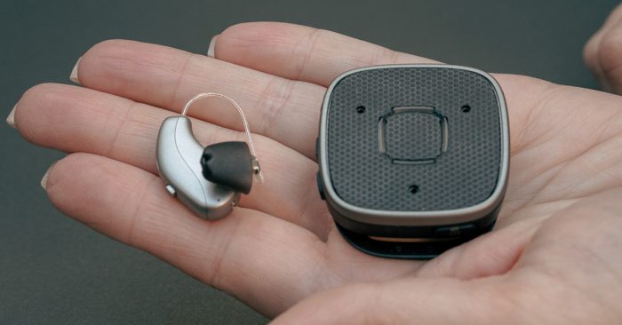 Widex Hearing Aid on the left with a Widex Sound Assist on the right