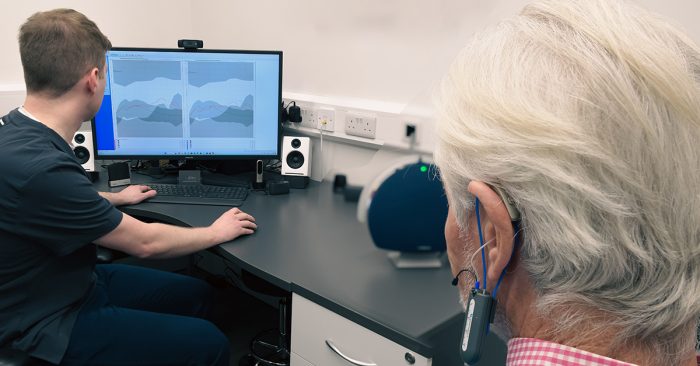 Man having real ear measurements conducted with an audiologist at Alto Hearing