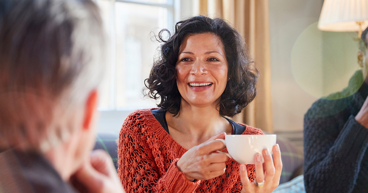 Woman having conversation drinking hot drink