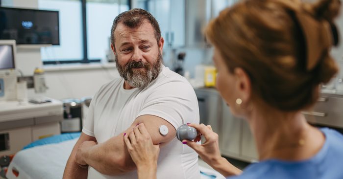 Diabetes and hearing loss: man in medical facility checking on diabetes