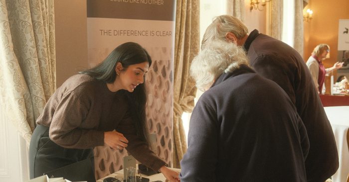 Staff from Widex showcasing the latest hearing aid technology at the Hearing Event in Market Bosworth