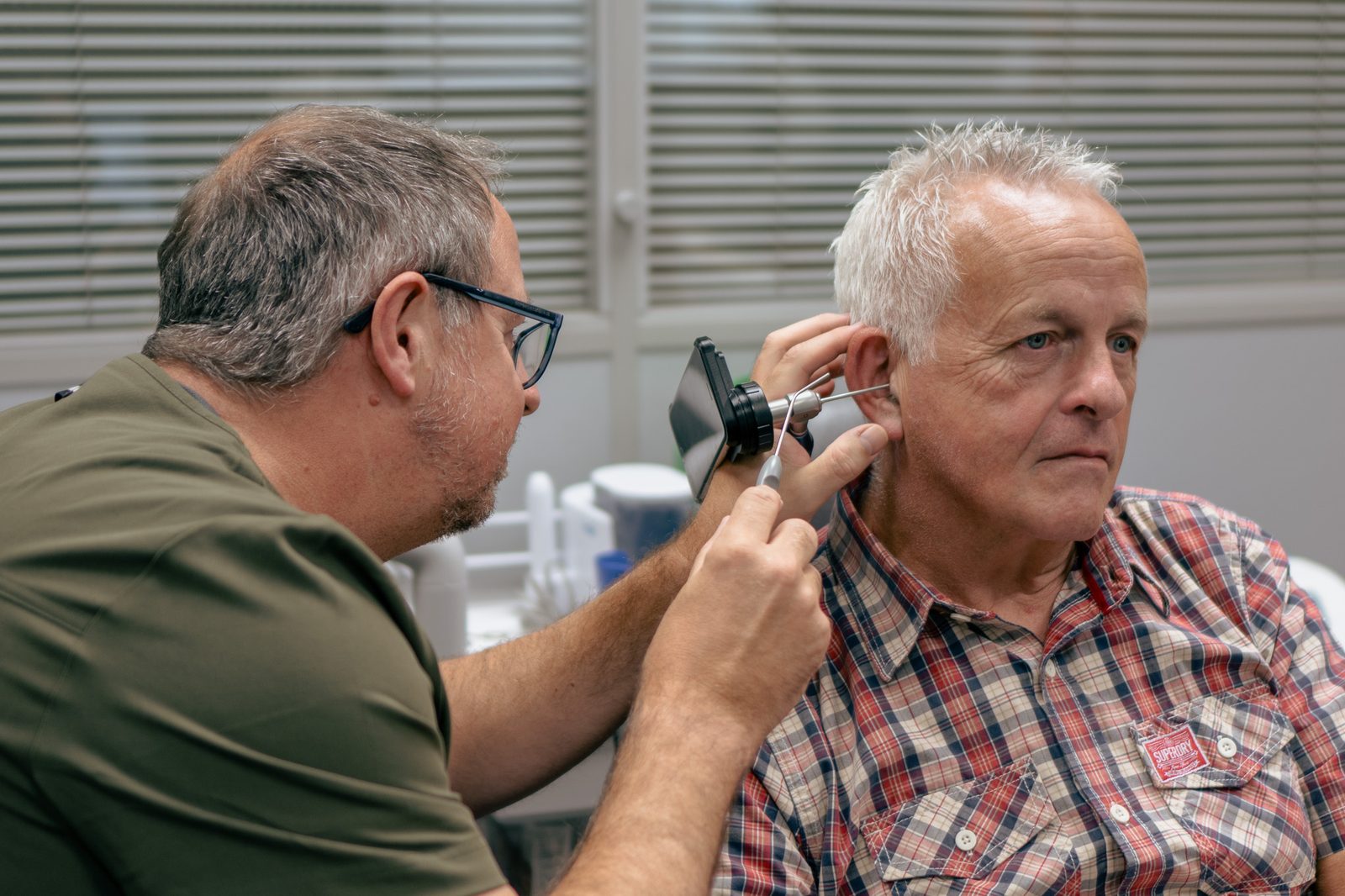 Carl Morley carrying out ear wax removal at Alto Hearing Market Bosworth
