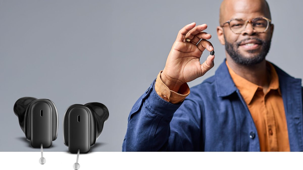 Signia Insio Charge&Go CIC IX custom hearing aid held between fingers