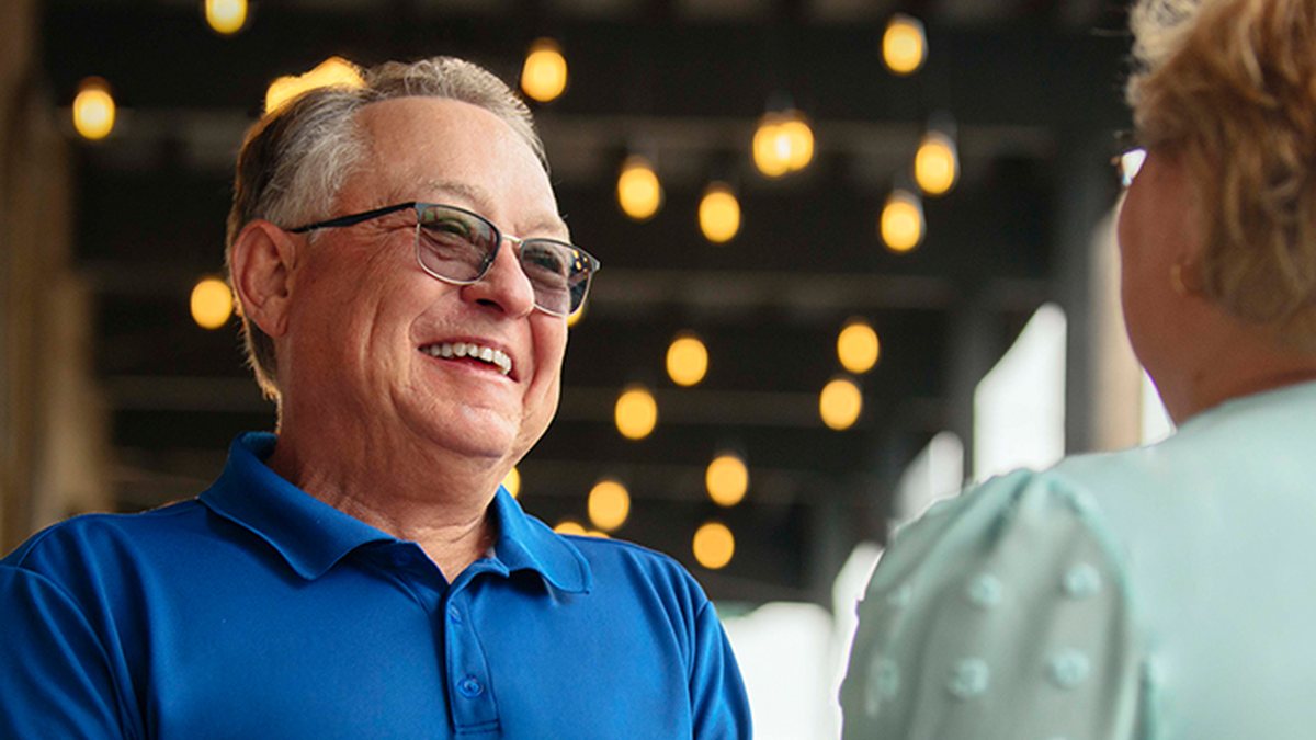 Man wearing Starkey Edge AI hearing aids in conversation
