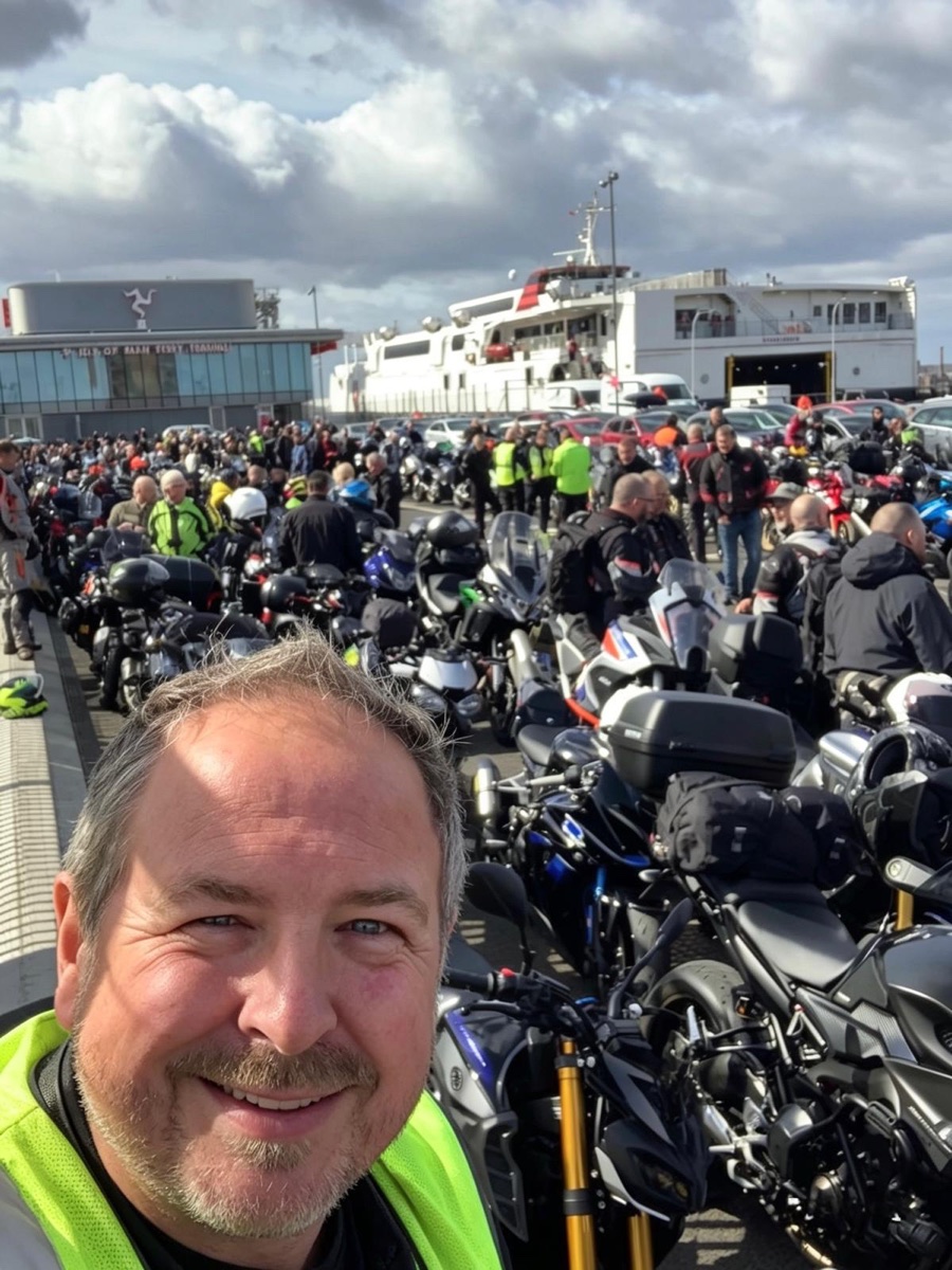 Carl Morley on a motorcycle trip with other riders waiting near a ferry