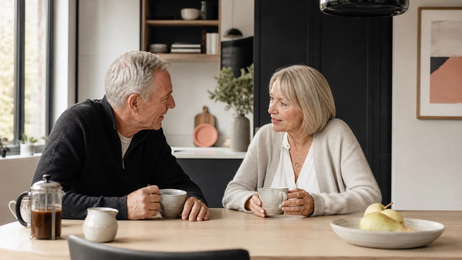 Older couple talking at home in an article about hearing aids and dementia risk