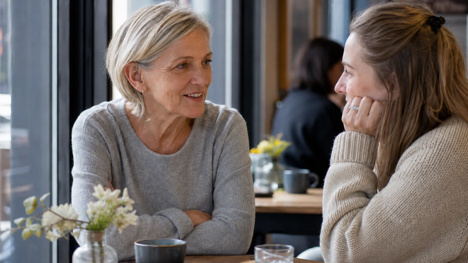 Woman discussing new treatments for hearing loss in 2027 with her adult daughter