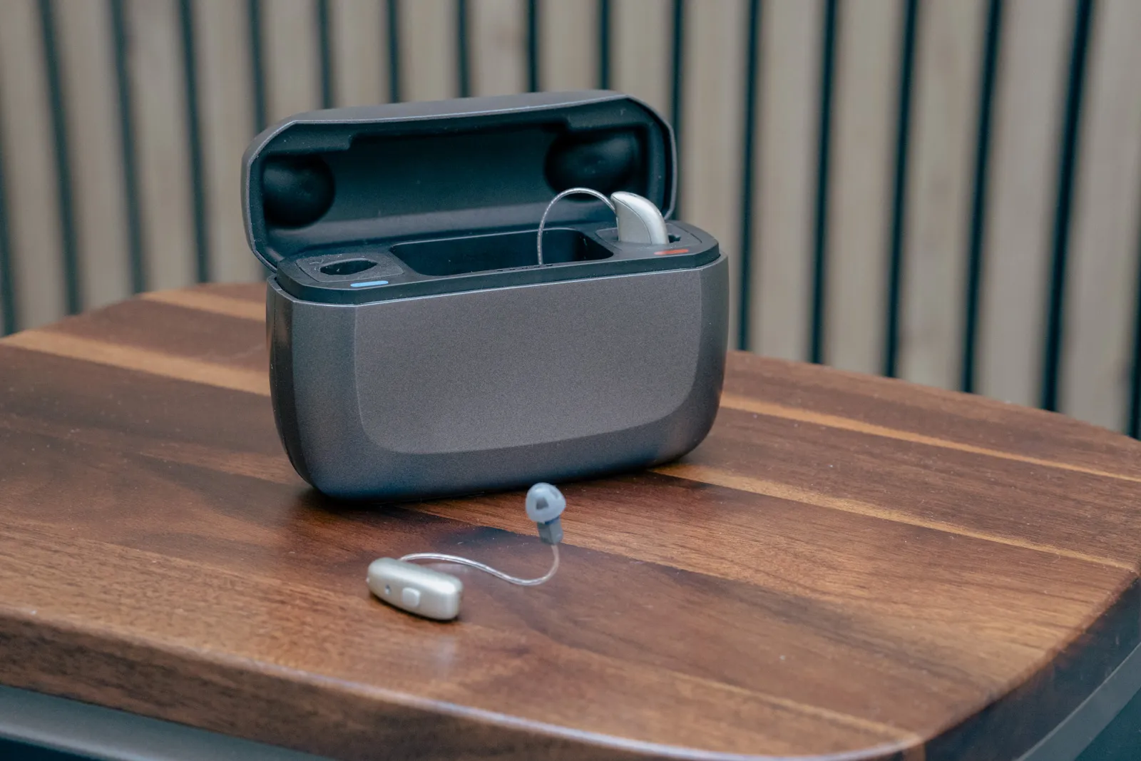 Rechargeable hearing aids with their charging case on a table at Alto